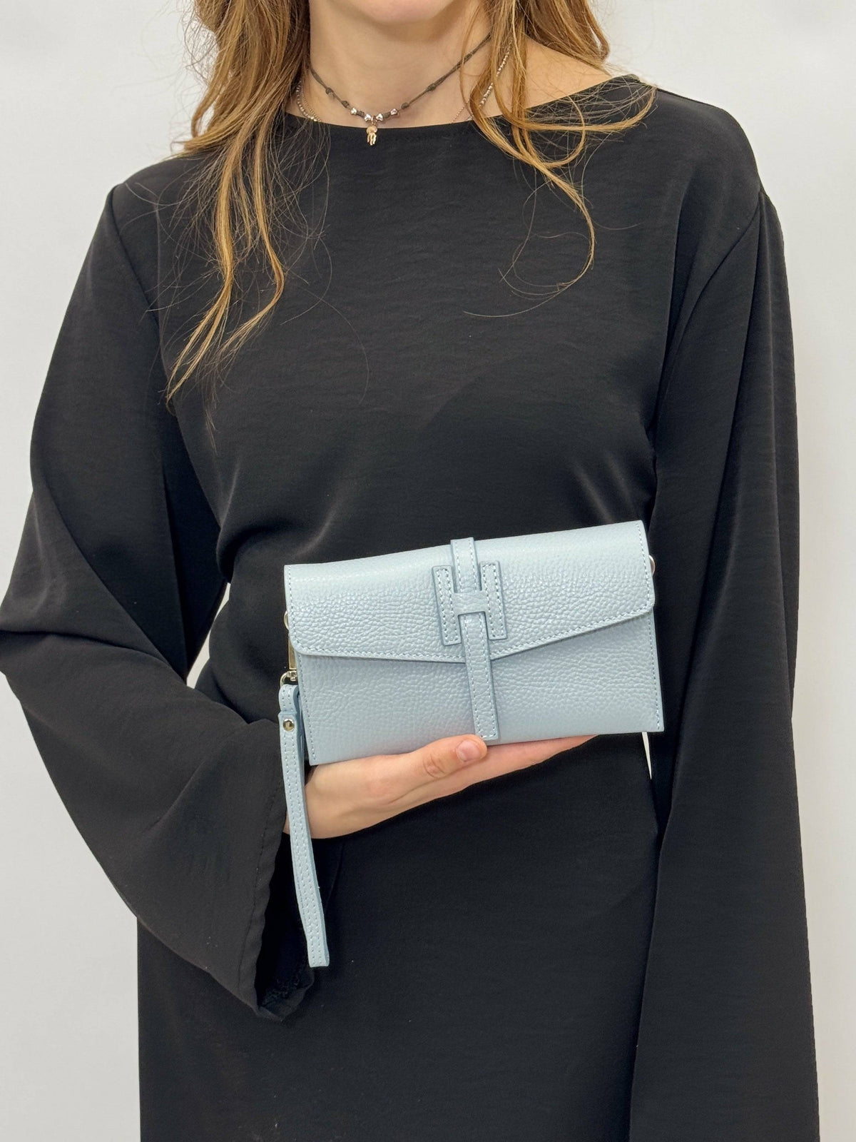 Yael™ clutch bag strap in soft luxurious fabrics, stylish accessory for Emma & Rose Cape Town borse, shown on a clutch bag.