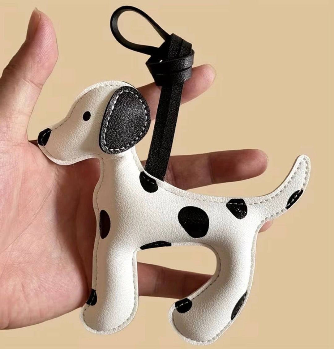 Dalmatian-shaped bag charm from Emma & Rose Cape Town, featuring black and white spotted design on a keyring attachment.