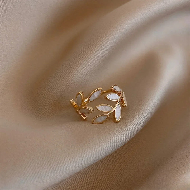 Emma & Rose Cape Town Anke™ adjustable gold ring with a delicate leaf design, perfect for elegant jewelry styling.